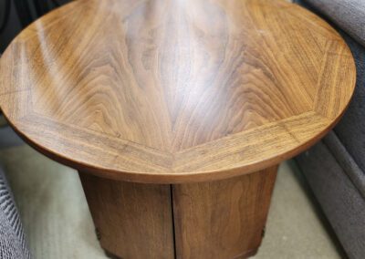 Round wooden table between couches.