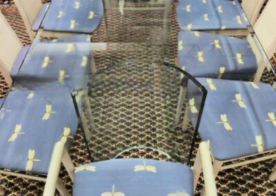 Glass table with dragonfly-patterned chairs.