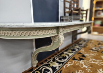 Elegant carved table with intricate leg design.