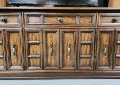 Wooden dresser with drawers and cabinet doors.