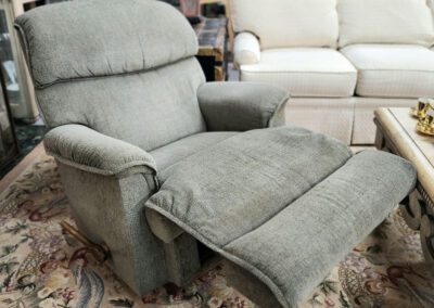 Gray recliner chair in living room setting.