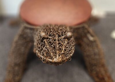 Turtle stool with intricately woven design.