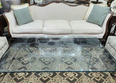 Elegant living room with glass coffee table.