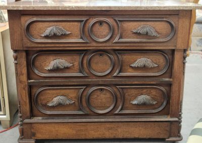 Antique wooden dresser with ornate carvings.