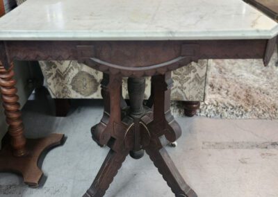 Antique wooden table with marble top.