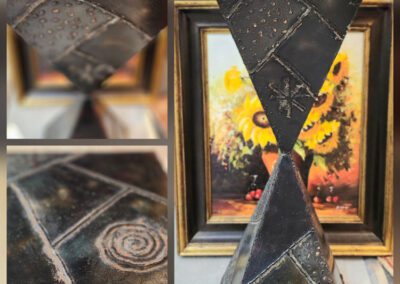 Geometric sculpture with intricate engraved patterns.