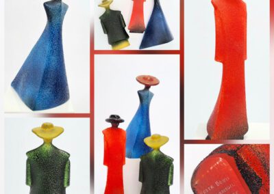 Colorful abstract sculptures with hats displayed together.