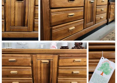 Wooden dresser with multiple drawers and cabinet.