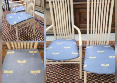 Wooden chairs with dragonfly-patterned cushions.