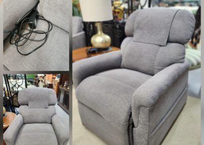 Gray recliner chair with remote control.