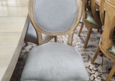 Gray upholstered chair at dining table.