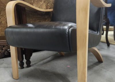 Black leather chair with wooden arms.