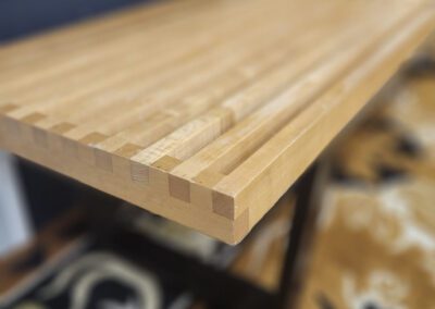 Wooden table with dovetail joints, blurred background.