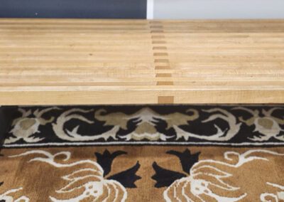 Wooden bench on patterned carpet.