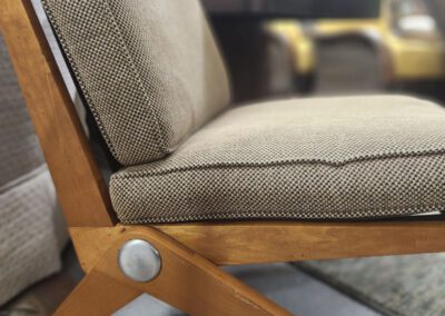 Mid-century modern chair with wooden legs.