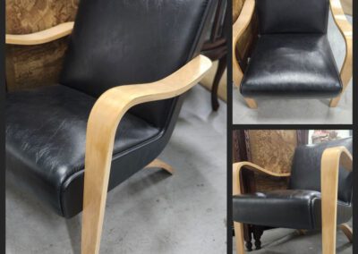 Black leather chair with wooden arms.