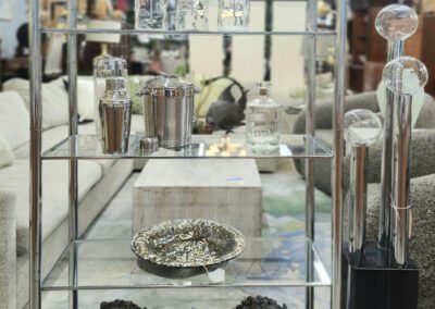 Glass shelves with decor and lion statues.