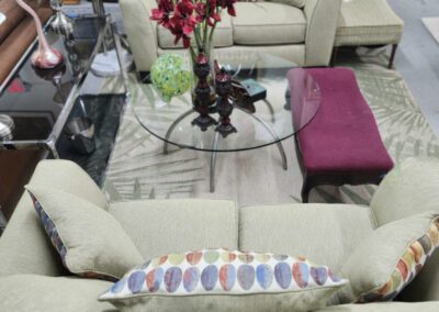 Living room setup with green sofas and table.