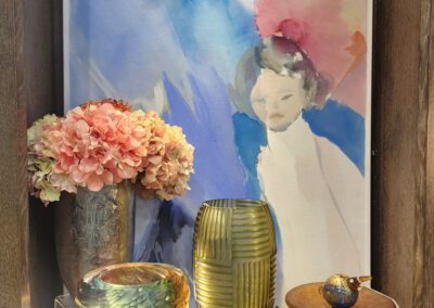 Art display with vases and floral arrangement.