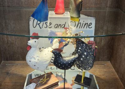 Colorful figurines displayed on glass shelf.