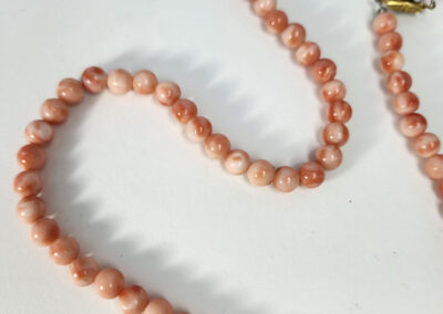Peach bead necklace on white background