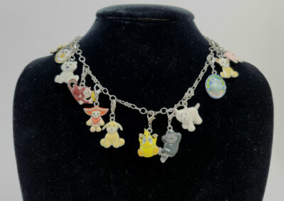 Colorful cartoon charm necklace on black velvet