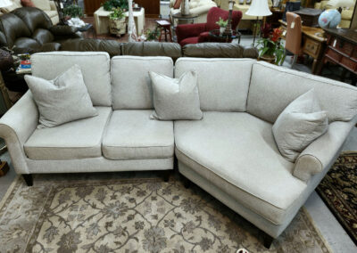 Light gray L-shaped sectional sofa with pillows