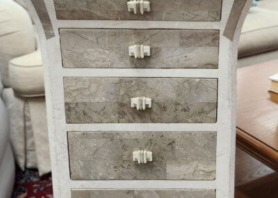 Tall narrow marble-front chest of drawers