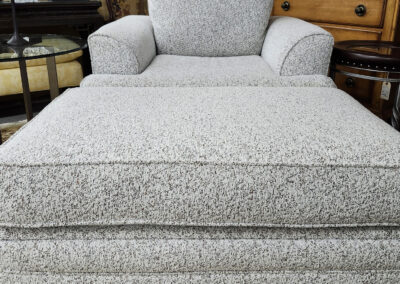 Gray upholstered armchair with matching ottoman