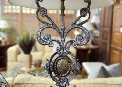 Ornate metal table lamp with white shade