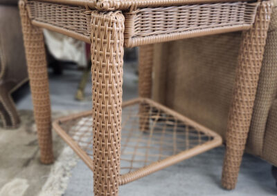 Woven wicker side table beside sofa