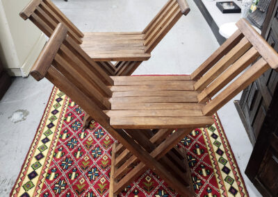 Wooden folding chairs on patterned rug