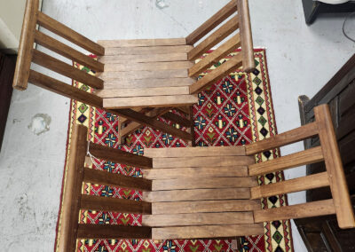 Two wooden folding chairs on patterned rug