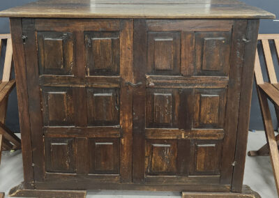 Rustic dark wood cabinet with paneled doors