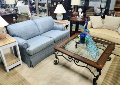 Furniture showroom with blue sofa and peacock