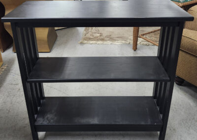 Black wooden three-shelf console table