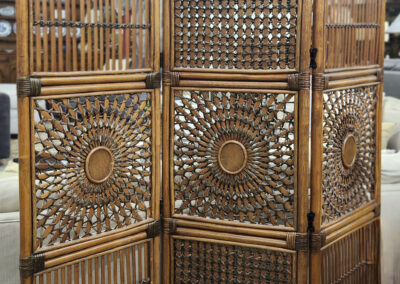 Woven rattan folding room divider with sunburst panels