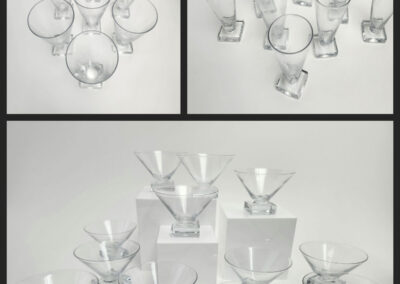 Clear martini glasses arranged on white background