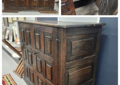 Antique dark wood paneled cabinet with shelves