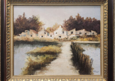 Framed painting of white cottages by water