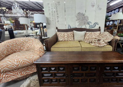 Brown sofa, patterned chair, wooden coffee table