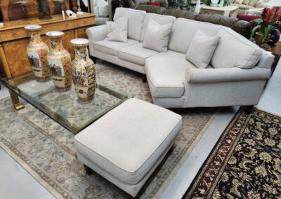 Light gray sectional sofa with ottoman and vases