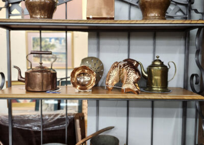 Copper cookware and decorative vessels on shelf