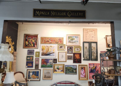 Art gallery storefront with framed paintings