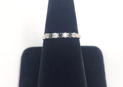 Five-stone diamond ring on black velvet display