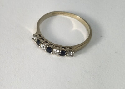 Gold ring with alternating sapphires and diamonds