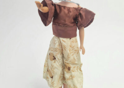Vintage Barbie doll wearing brown top and skirt