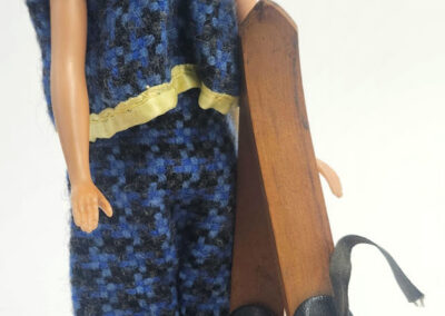 Vintage fashion doll holding wooden skis