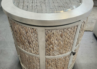 Round wicker side table with glass top