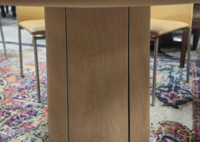 Round wooden dining table pedestal on rug